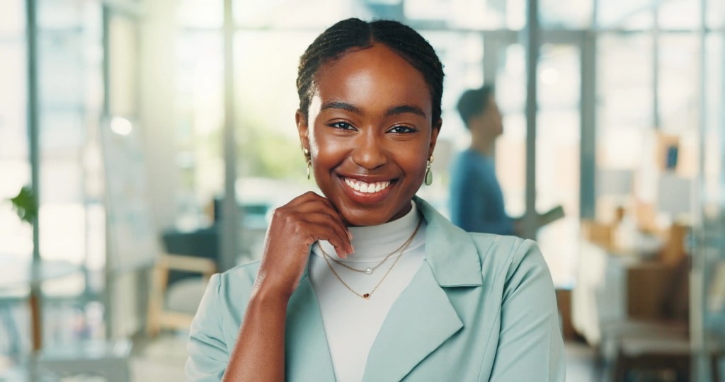 Portrait confident woman with smile office journalist internship career development trainee reporter person with experience opportunity happiness creative newsroom